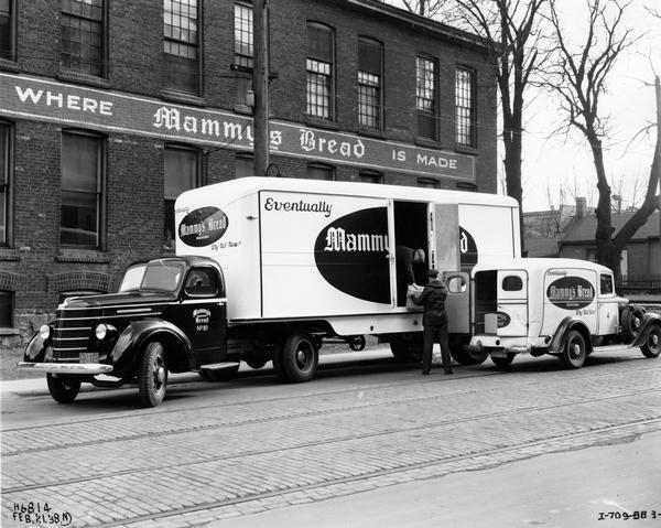 Men loading goods into an International D-30 delivery truck for "Mammy's Bread."
