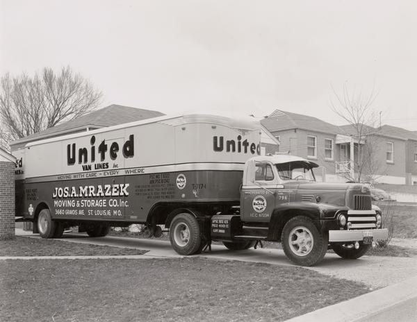 International L-185 moving truck owned by United Van Lines parked in a residential driveway.