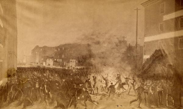 A photograph of a painting depicting the bomb exploding at police as they approach the wagon to tell the crowd to disperse from Haymarket Square. Shrapnel can be seen flying through the air as police are hit and the crowd runs. The rally gathered thousands protesting the killing by police officers of two union member McCormick reaper factory workers during a confrontation between the union workers and their replacements the previous day. A riot erupted after the bomb explosion.
