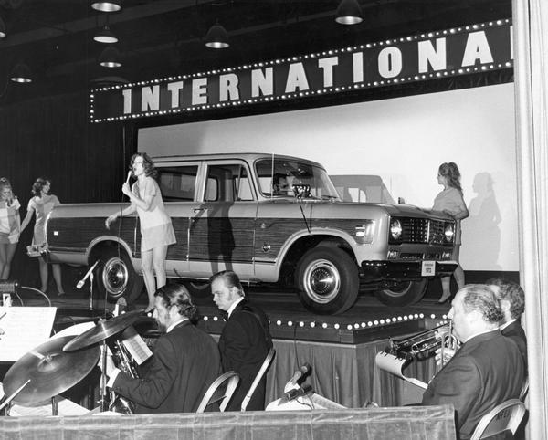 Musical performers, including a band and a female singer, introducing the new International 1210 Wagonmaster pickup truck. The truck was a special edition of the Travelette.
