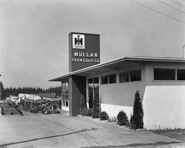 "Prototype" dealership building of the Mullan Farm Equipment Company. An OS-4, Farmall C and Farmall AV tractor are parked outside the building. This "prototype" dealership building was built as part of International Harvester's "Dealer Base of Operations Program." By February of 1948, 386 dealerships had been built on the prototype plan. Another 617 dealerships were under construction or had been built on a modified prototype plan. Eventually over 1800 such dealerships were built worldwide.