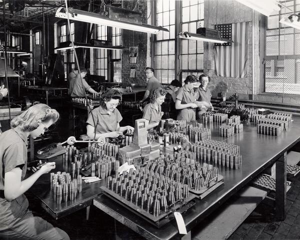 Factory workers at International Harvester's West Pullman Works inspecting 37-millimeter shells.