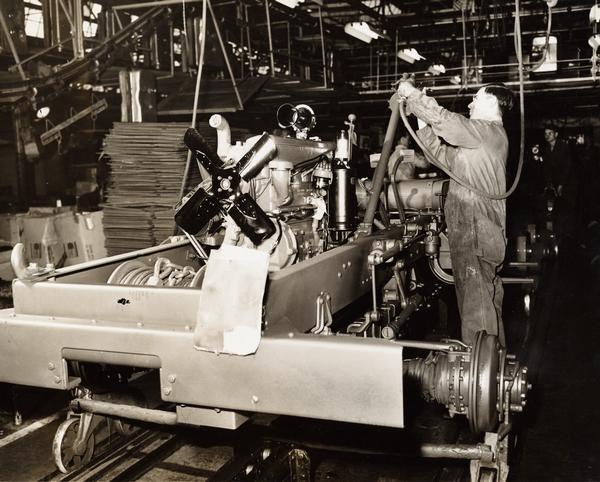 Factory workers assembling the steering gear on a military truck at International Harvester's Fort Wayne Works.