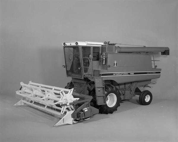 Advertising photograph of an International 1460 axial-flow combine with grain header. The axial-flow feature allowed for more complete threshing and separation by flowing crops through the threshing mechanism parallel to the axis of the rotor, as opposed to perpendicularly.