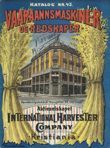 Cover of an International Harvester farm implement catalog written in Norwegian. The cover has a drawing of a city street in Oslo with an International Harvester Company building on the corner. The scene is framed by bundles of wheat. The address (in blue text) translates to "Sales Premises Stogaten 28, 2nd Floor". The title of the catalog (in red text) translates to approximately, "Farming Machinery and Implements".