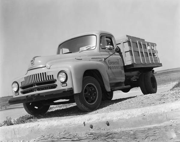 International L-line truck hauling produce. The L-line was promoted as "a truck for every hauling job" and featured an innovative "Comfo-Vision" cab with one-piece curved "Sweepsight" windshield.