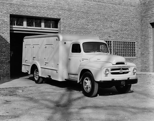 International R-172 ice cream truck with mechanically refrigerated body. The truck is backing up to a loading dock.