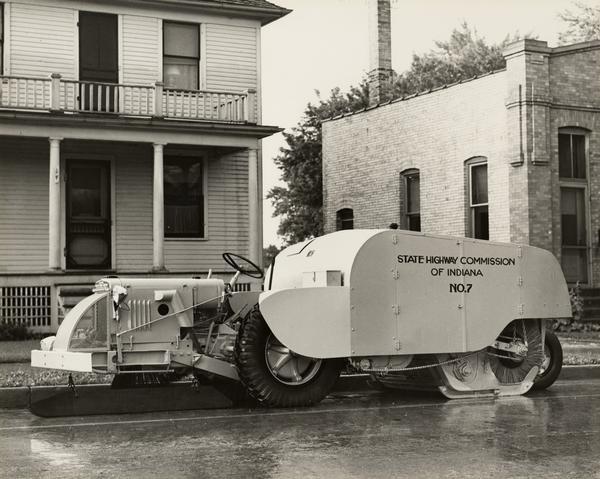 Street cleaner owned by the State Highway Commission of Indiana parked on a city street. The street cleaner was manufactured by the Frank G. Hough Company.