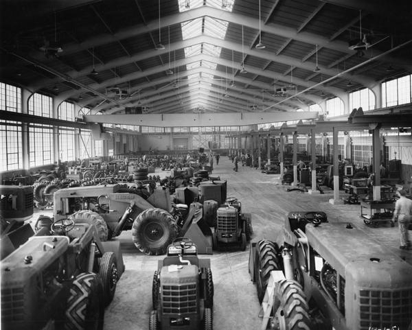 Front loaders (payloaders) on the floor of the Frank G. Hough Company factory (works). The company manufactured construction and industrial equipment. The company was eventually purchased by the International Harvester Company.