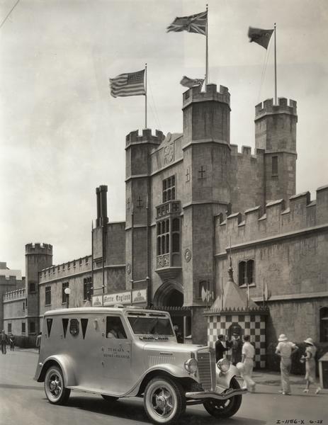 Armored C-30 truck built for Brinks Incorporated parked in front of a castle in the "Irish Village" exhibit at the "A Century of Progress" world's fair in Chicago.
