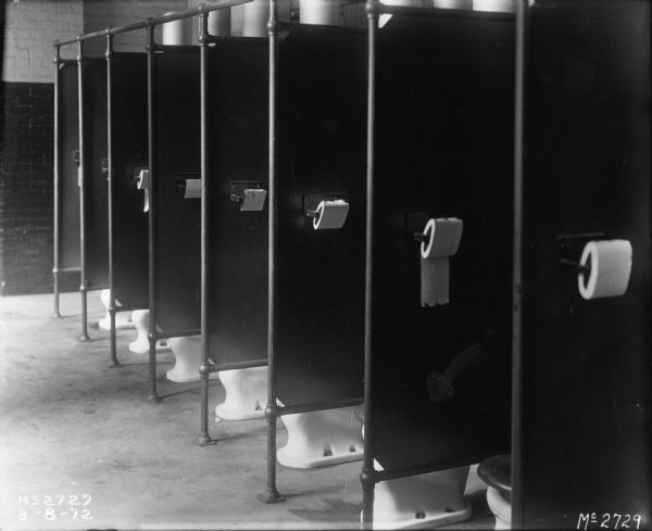 Toilet stalls in the employee bathroom at International Harvester's McCormick Works (factory).