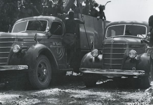 Native Africans ride in the back of an International truck during Commander Atillio Gatti's tenth African expedition. The Expedition was sponsored by International Harvester Company. International custom-built the trucks for the expedition.
