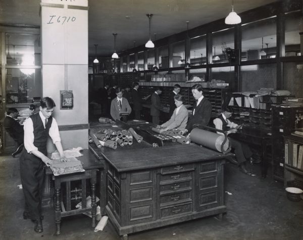 Workers packaging publications in the offices of Harvester Press, International Harvester's in-house print shop.