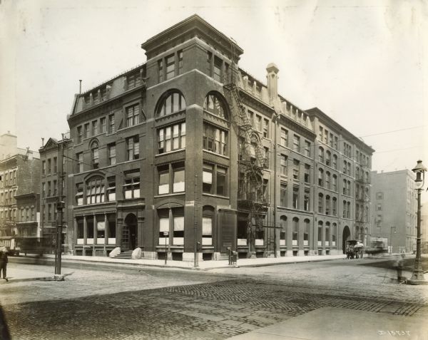 The exterior of the Harvester Press building on Adams Street. Original caption reads: "Harvester Print Shop -- Adams Street, Chicago.  Relocated to 4829 S. Kedzie Avenue, Chicago in 1923."