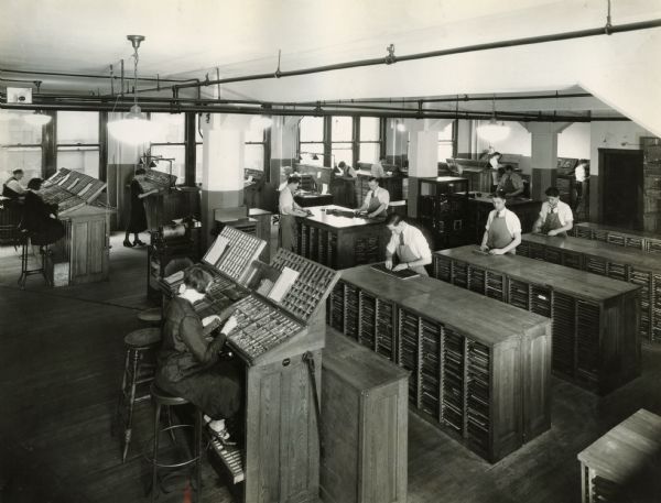 Workers typesetting in the offices of Harvester Press, International Harvester's in-house print shop.