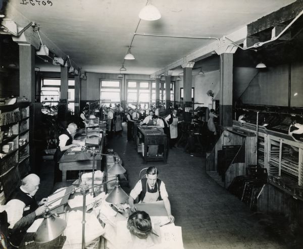 Employees working in the offices of Harvester Press, International Harvester's in-house print shop.