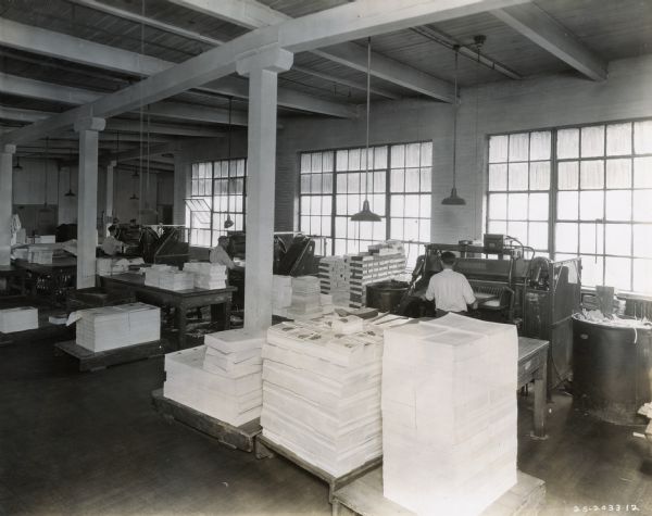 Slightly elevated view of workers at Harvester Press, International Harvester's in-house print shop.