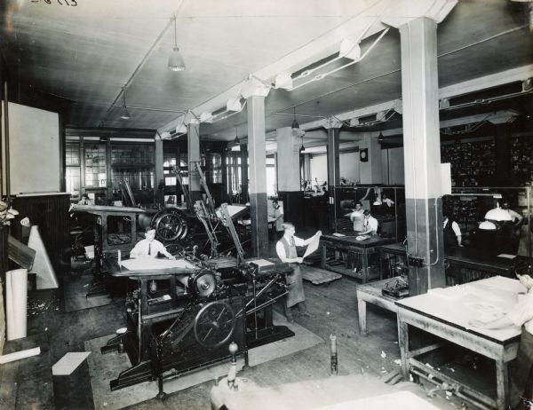Men operating printing presses at Harvester Press, International Harvester's in-house print shop.
