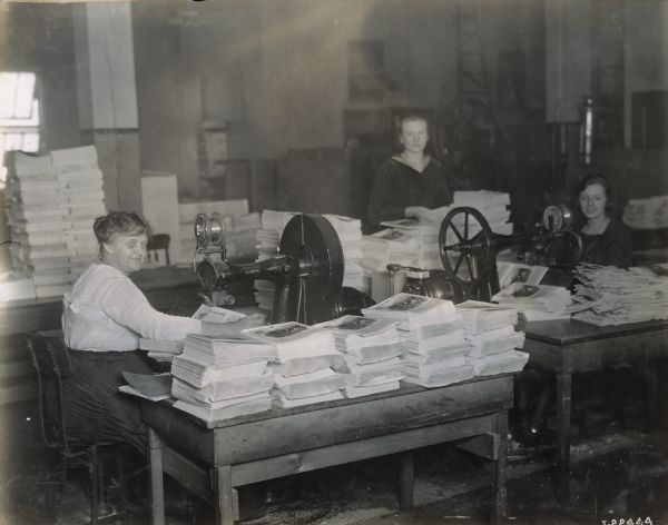 Women sewing the bindings of publications at Harvester Press, International Harvester's in-house print shop.