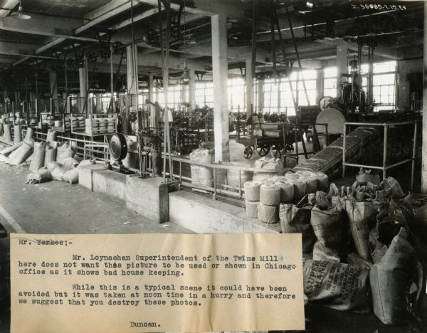 Vacant packaging room at International Harvester's Hamilton Twine Mill, Hamilton, Ontario, Canada. Attached caption reads: "Mr. Yerkes:  Mr. Loynachan Superintendent of the Twine Mill here does not want this picture to be used or shown in Chicago office as it shows bad house keeping. While this is a typical scene it could have been avoided but it was taken at noon time in a hurry and therefore we suggest that you destroy these photos. Duncan."