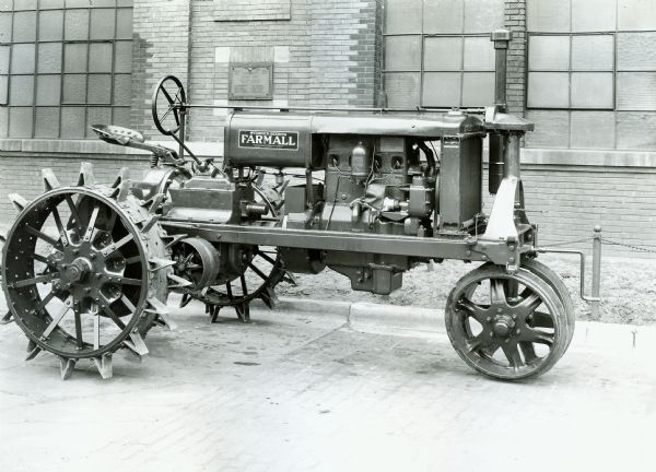 International Harvester engineering department photograph of an experimental Farmall tractor. The original caption reads: "15-30 Farmall Tractor (redesigned) - right side view." An Honor Roll plaque is on the wall behind the tractor, and reads, in part: "World War 1917 1919".