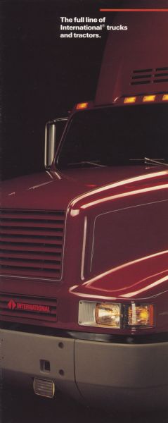Front cover of a brochure advertising: "The full line of International trucks and tractors." Features a color photograph of a semi tractor hood.