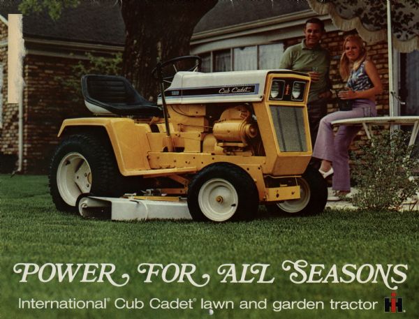 Front cover of an advertising brochure for Cub Cadet lawn and garden tractors. The color photograph shows a yellow Cub Cadet tractor on a lawn with a brick house and patio in the background. A man and a woman are on the patio holding drinks. A caption reads: "Power for All Seasons."