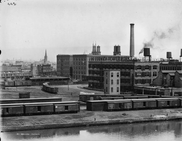 Elevated view across canal of the McCormick Reaper Works, rail yard, and surrounding buildings. After 1902, the factory became International Harvester's McCormick Works.