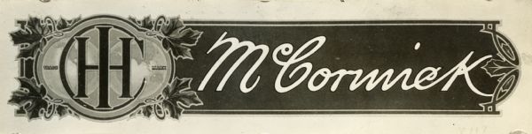 Photograph of a decal used on the seat springs of implements manufactured for the Canadian market. The decal shows an International Harvester trademark (logo) bordered by grape leaves on the left hand side of the image and "McCormick" in script on the right hand side.
