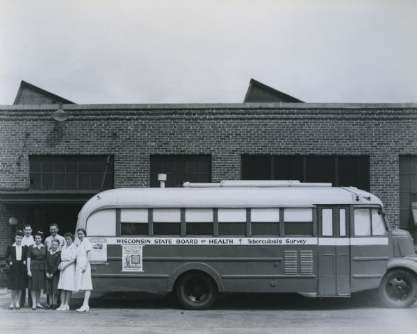 Wisconsin State Board of Health Tuberculosis Survey bus with staff posing.