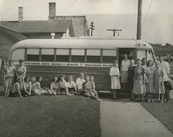 Wisconsin State Board of Health Tuberculosis Survey bus with staff posing in front.