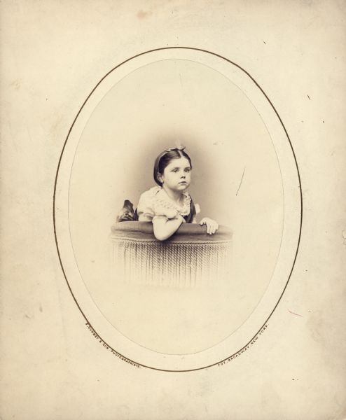 Oval framed vignetted portrait of Mary Virginia McCormick (1861-1941) as a young girl. Mary Virginia was the daughter of Chicago industrialist and inventor, Cyrus Hall McCormick.