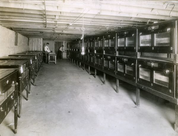 Two men working in the incubator room of U.R. Fishel.