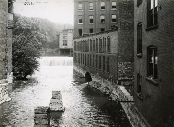Water pouring over a dam near International Harvester's Osborne Works. The factory was later known as "Auburn Works."