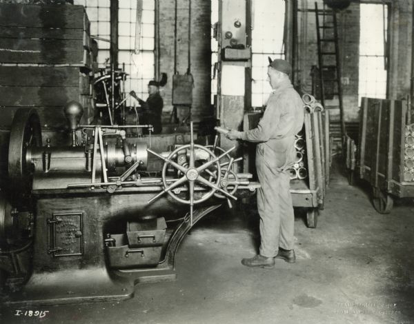 Factory workers operating marchinery at International Harvester's Plano Works. The factory was later known as "West Pullman Works."