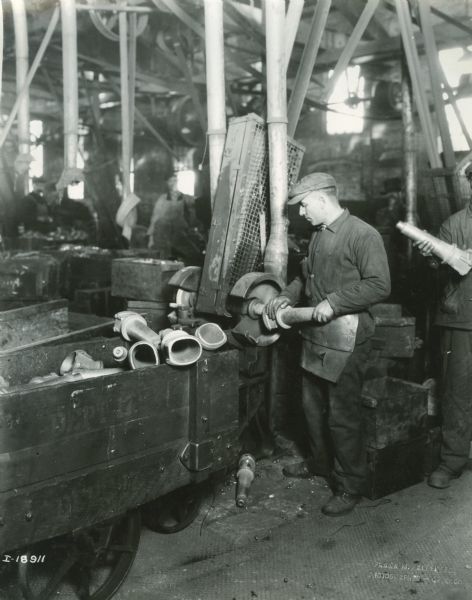 Factory worker operating machinery at International Harvester's Plano Works. The factory was later known as "West Pullman Works."