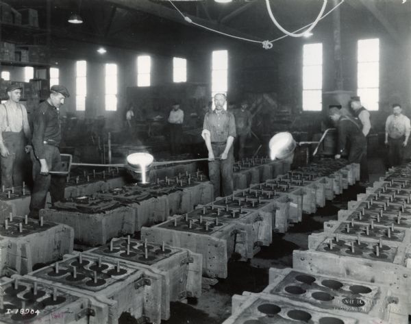 Factory workers pouring metal into molds at International Harvester's Plano Works. The factory was later known as "West Pullman Works."