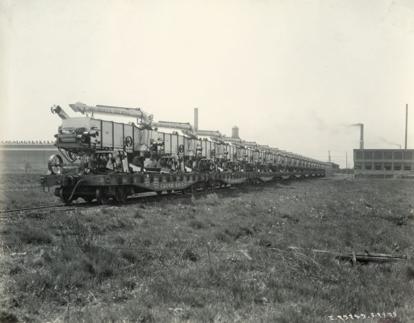 A train transports McCormick-Deering All-Steel threshers from International Harvester's Plano Works. The factory was later known as "West Pullman Works."