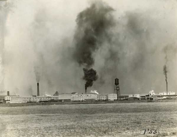 Buildings, a watertower, and smokestacks at International Harvester's Plano Works. The factory was later known as "West Pullman Works."