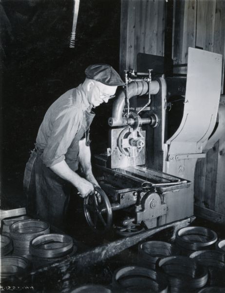 Factory worker at a machine at International Harvester's Rock Falls Works.
