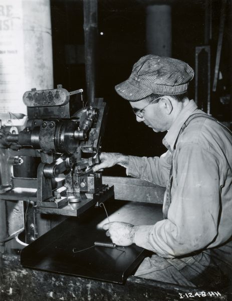 Factory worker at a machine at International Harvester's Rock Falls Works.