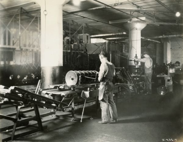 Factory workers working on discs for a harrow or plow at International Harvester's Rock Falls Works.