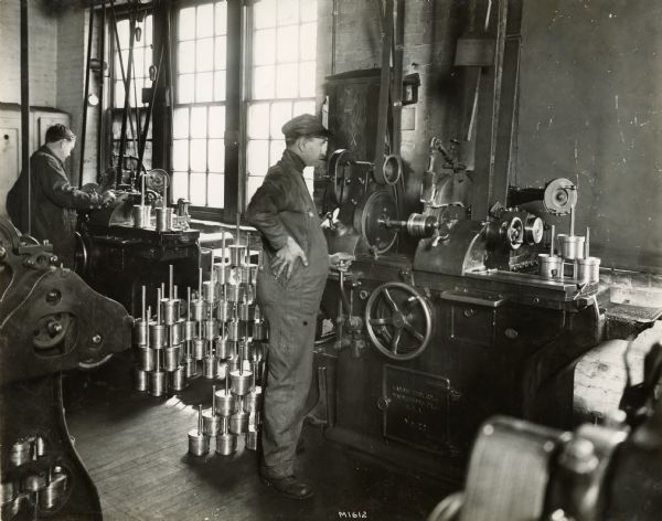 Factory workers machine parts at International Harvester's Milwaukee Works.