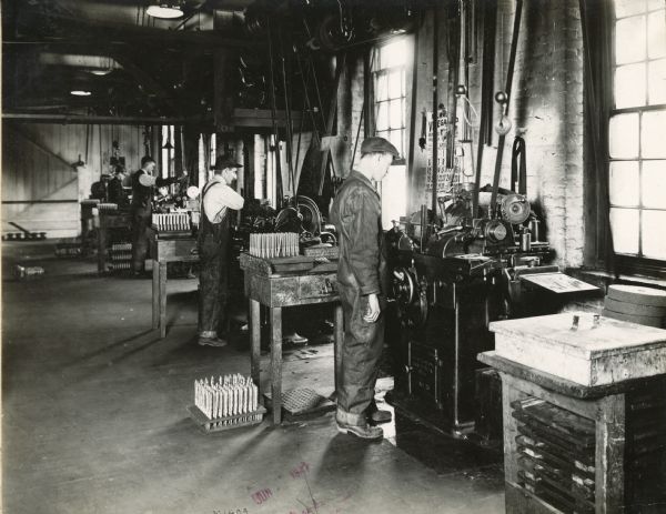 Factory workers operate machinery at International Harvester's Milwaukee Works.