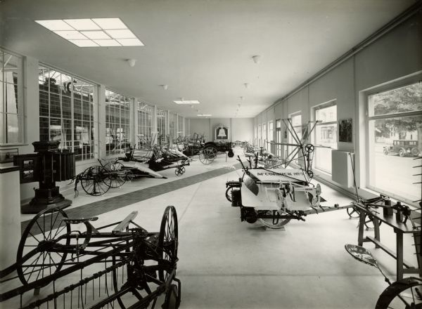 Grain binder, cultivator and other farm machinery in an International Harvester showroom in Berlin, Germany.