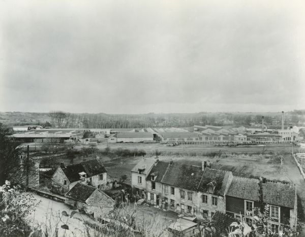 Elevated view of International Harvester's Montataire Works in Montataire, France. Dwellings are in the foreground.