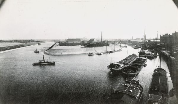 Boats and ships in a canal surrounding International Harvester's Neuss Works in Germany.