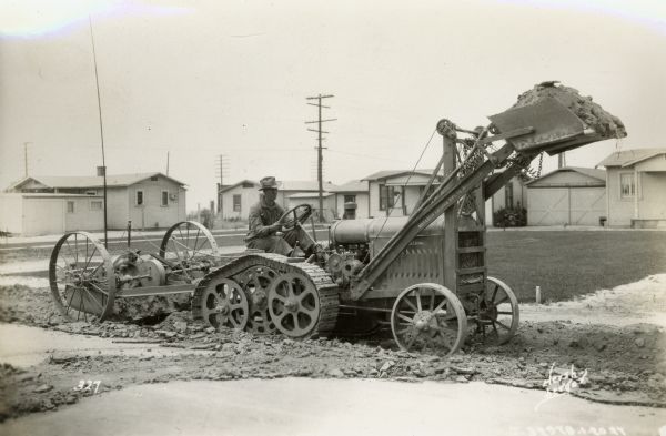 McCormick-Deering 10-20 industrial tractor with a crawler track and a Monarch loader.
