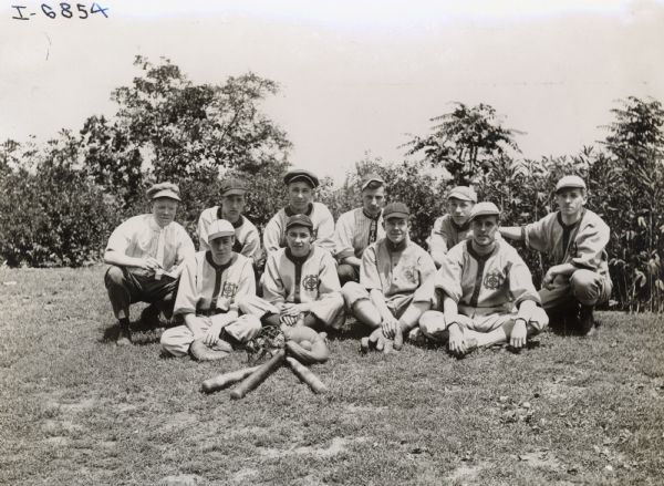 Young men in baseball uniforms, possibly members of an International Harvester company baseball team.