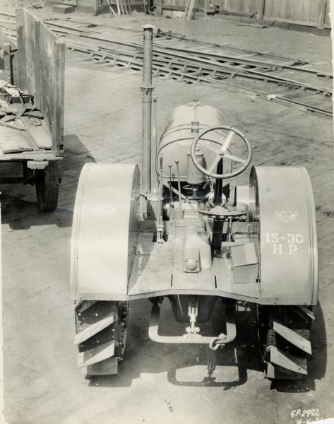 Engineering photograph of a 15-30 tractor showing the rear of the tractor with decals and stenciling visible.